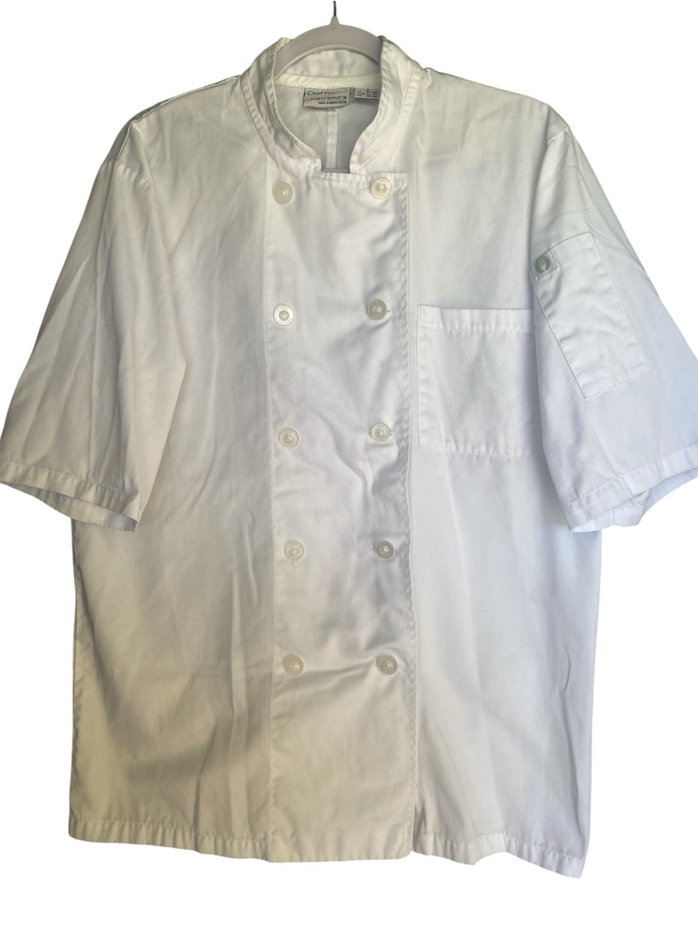 Small chef works white double breasted short sleeve chef, cloth covered button